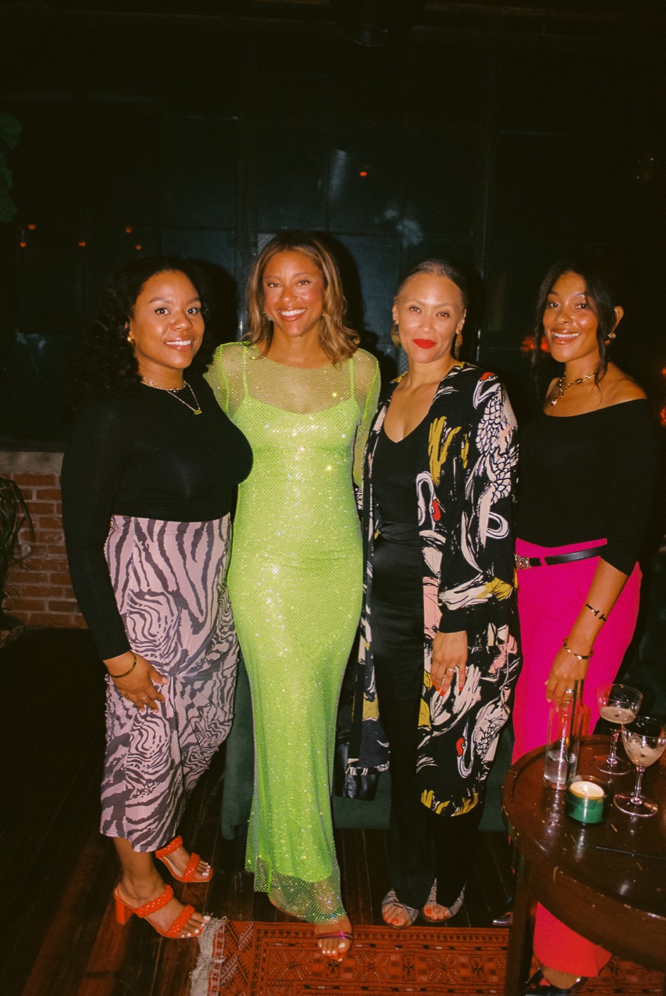 Four friends dressed up and smiling together